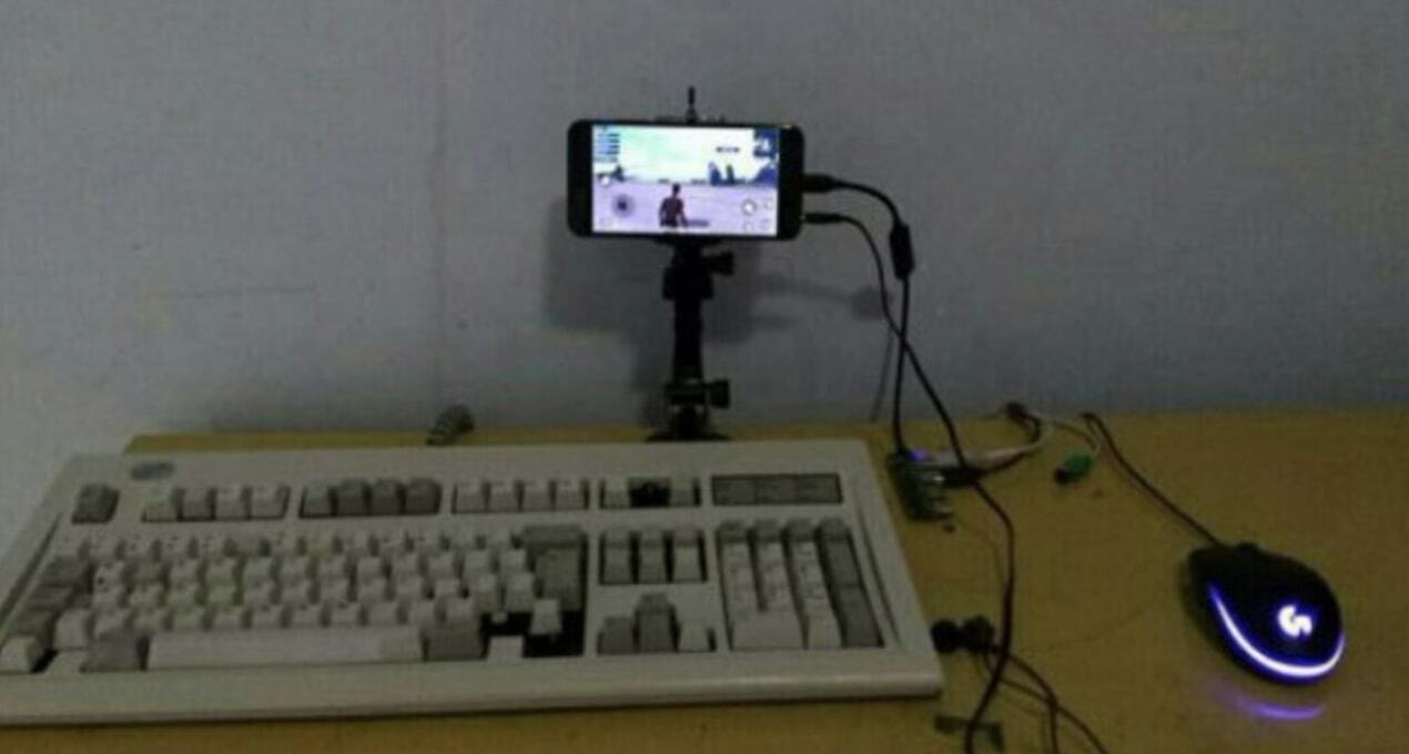 An old keyboard and mouse plugged into a smartphone