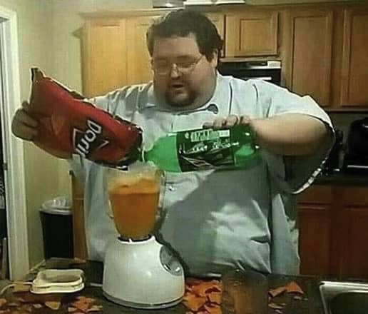 Guy pouring doritos and mtn dew into a blender