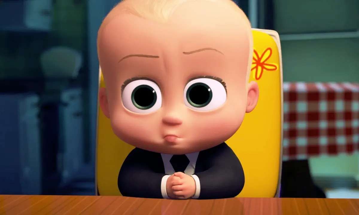 Boss baby sitting in his high chair in a suit