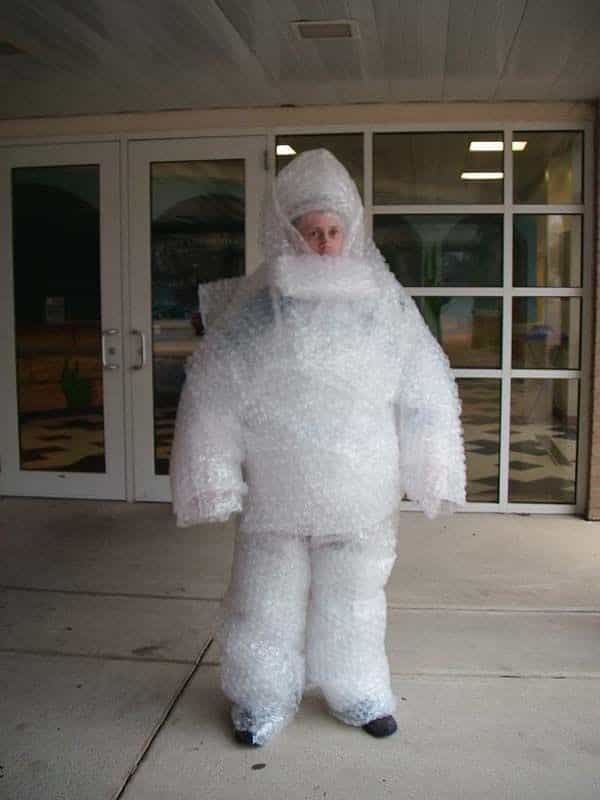 Boy wrapped in bubble wrap