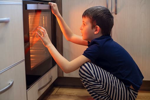 Boy looking into oven