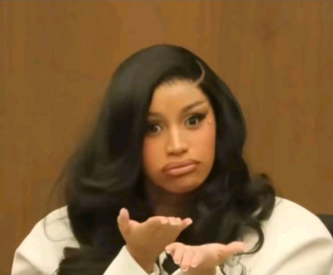 Cardi B in her trial looking frustrated at the camera