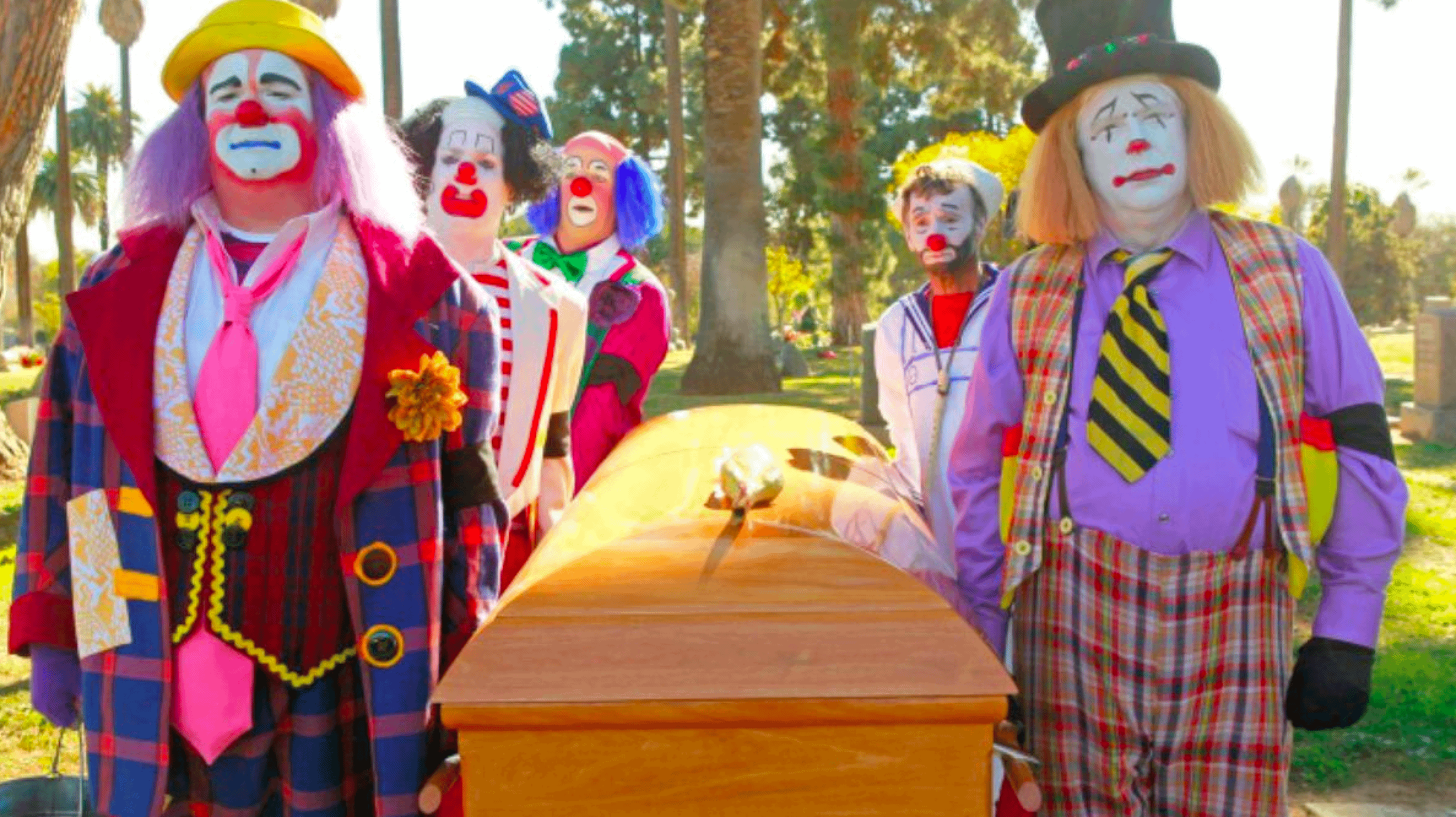 Clowns carrying a casket