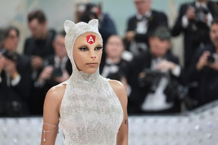 Doja Cat dressed up as a cat at Met Gala with Angular logo on her head jewel