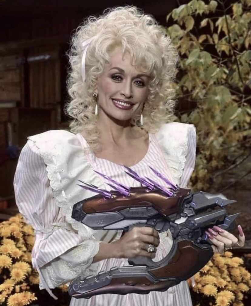 Dolly Parton holding a needler gun from Halo 2