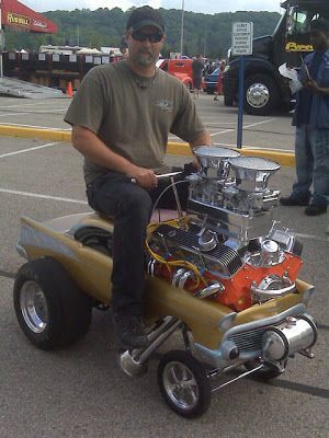 A guy in a tiny car with a huge engine