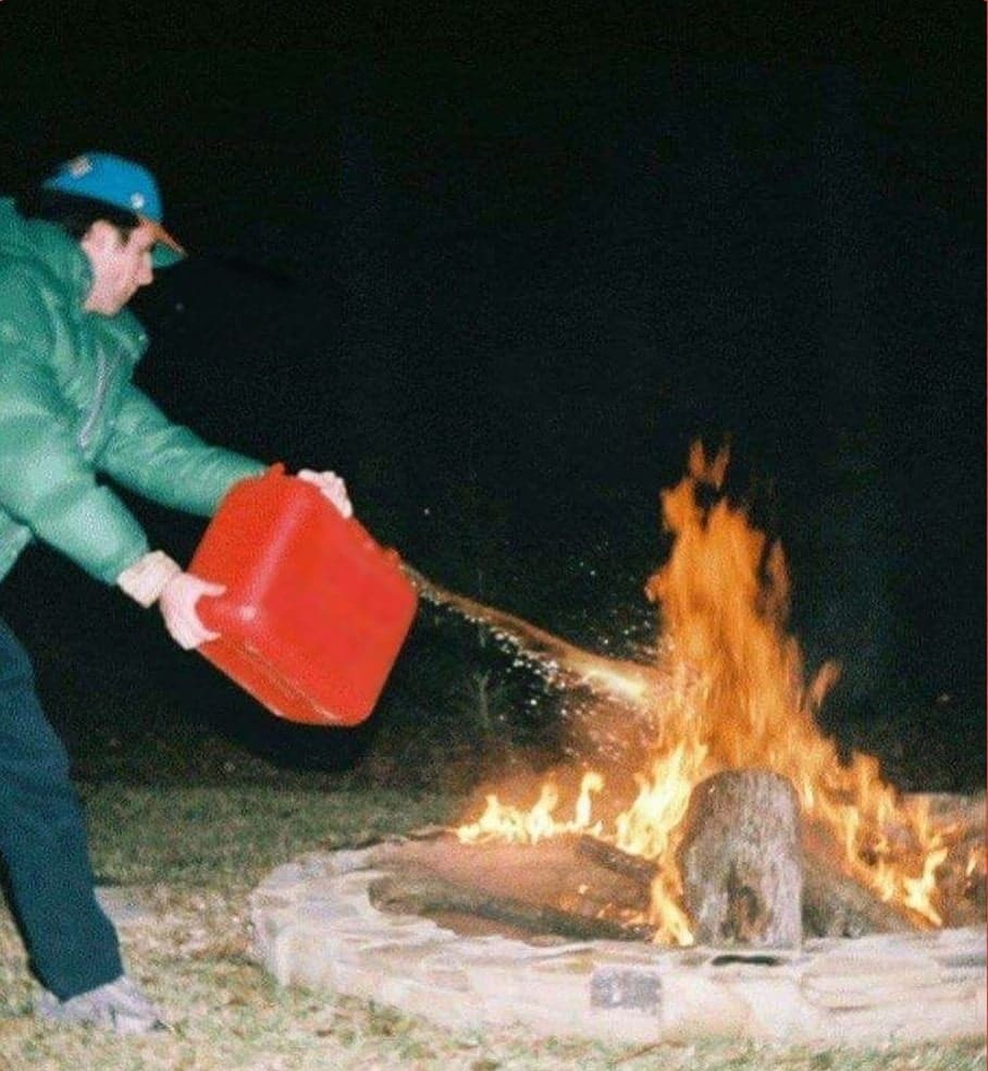 Guy pouring gasoline on fire