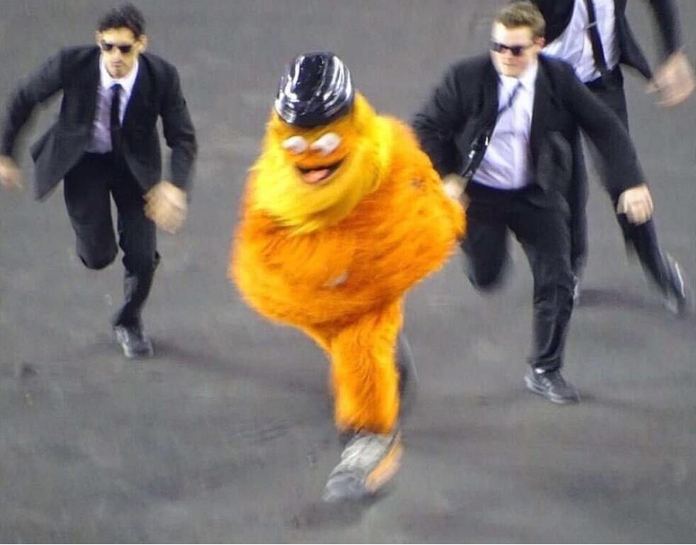 Gritty running away from men in suits.