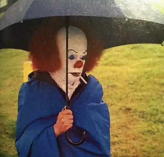 A sad clown smoking