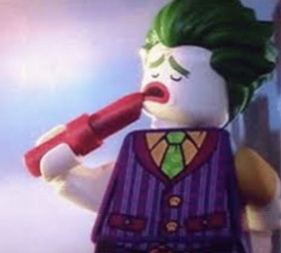 Lego Joker putting on makeup.