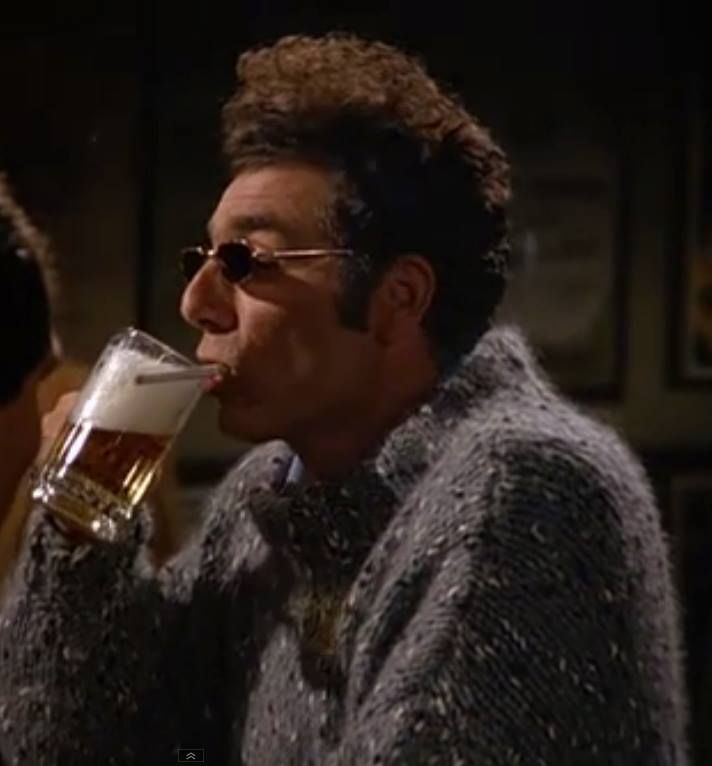 Kramer drinking a beer and smoking at the same time