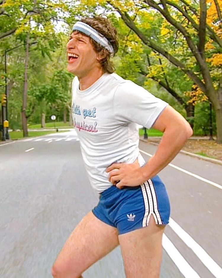 An exhausted jogger bent over with hands on knees catching their breath