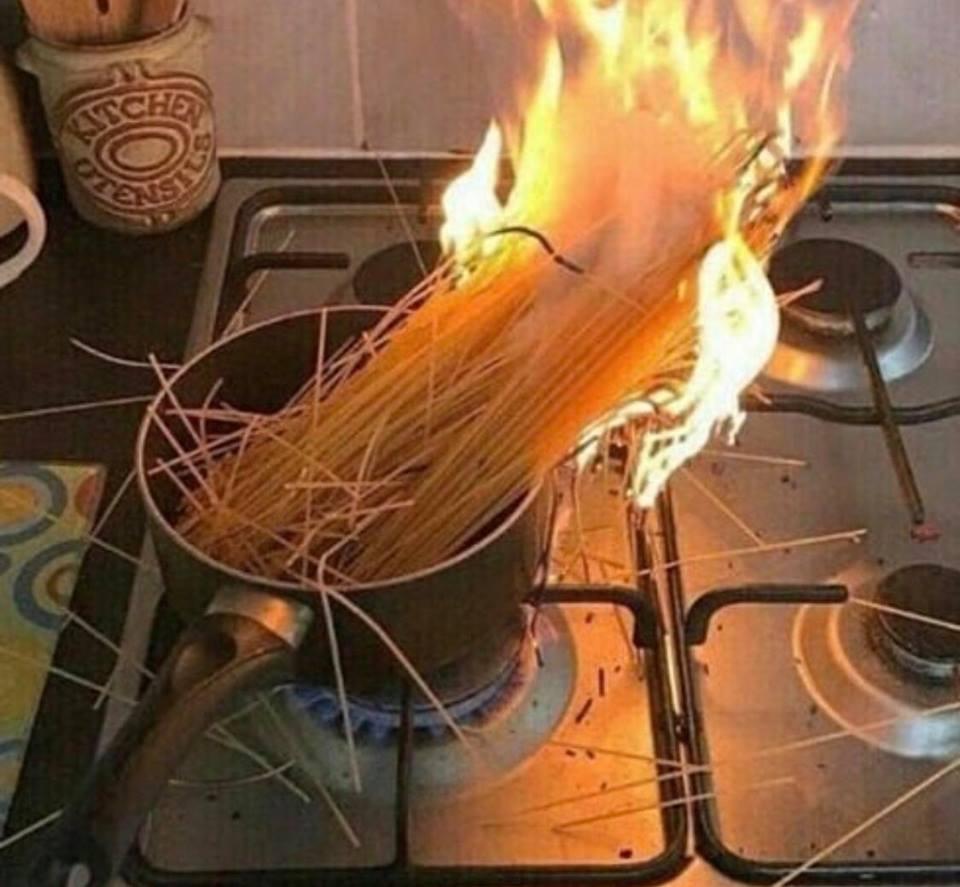 pasta on fire in a pot on the stove