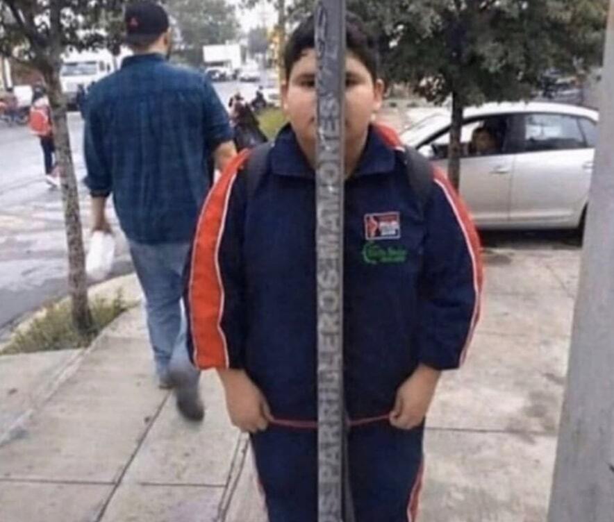 Kid trying to hide behind a pole