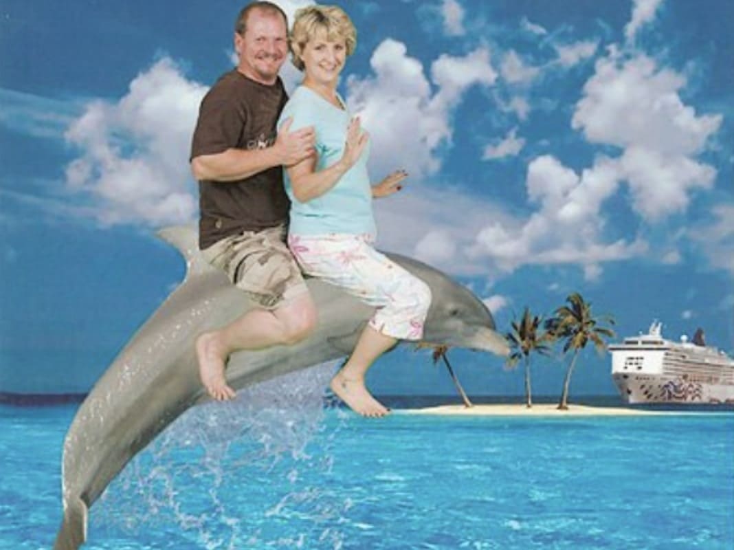 Husband and wife riding on the back of a dolphin