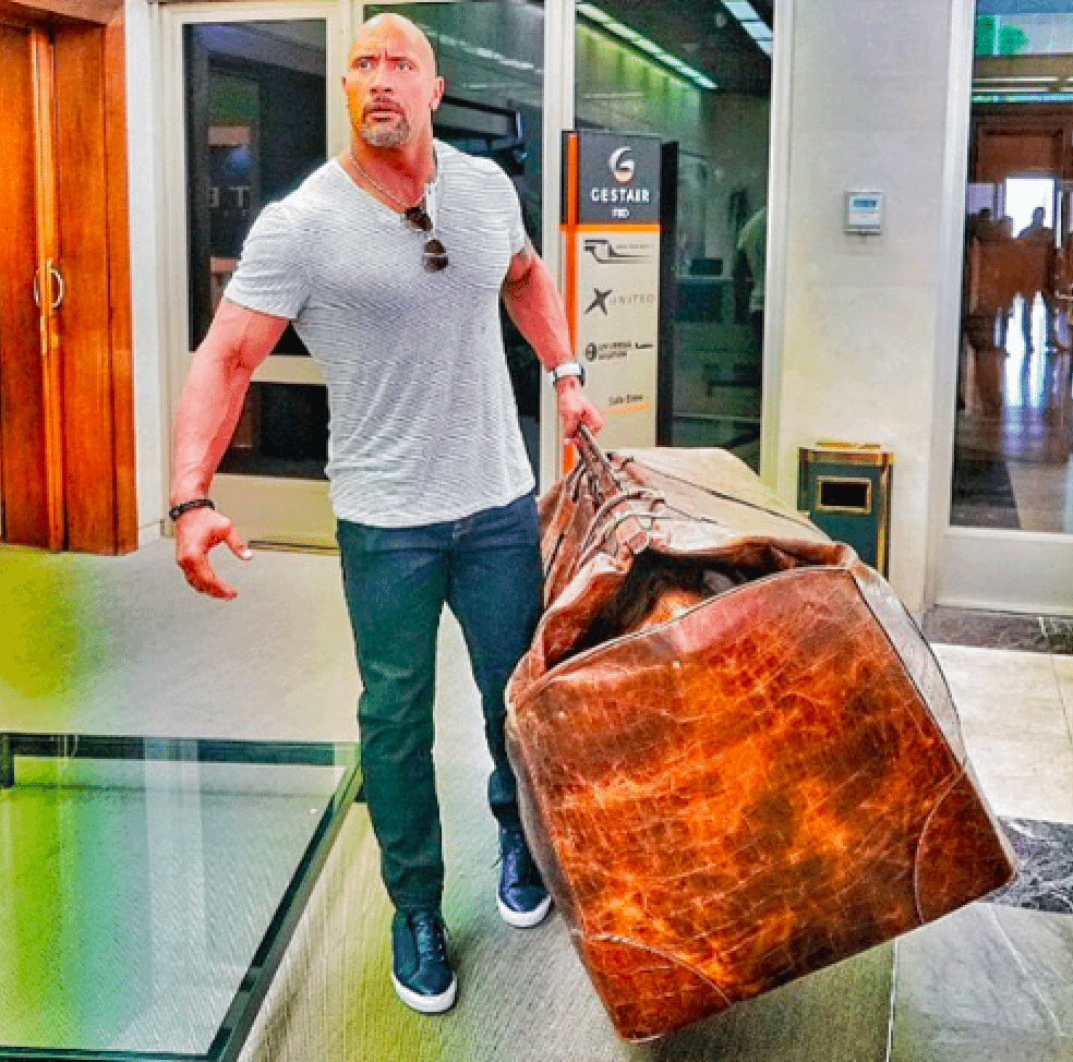 The Rock holding a large bag