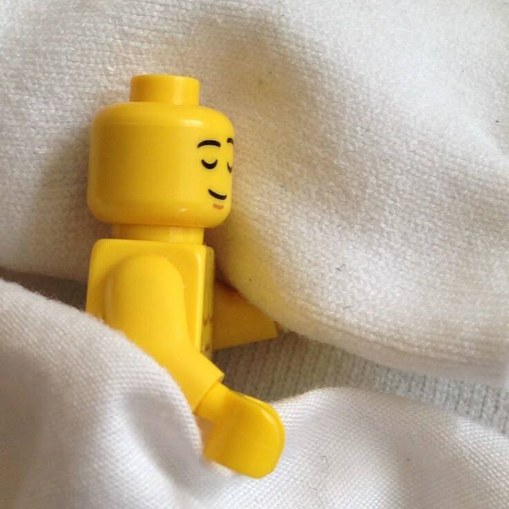 Lego minifig sleeping on a pillow