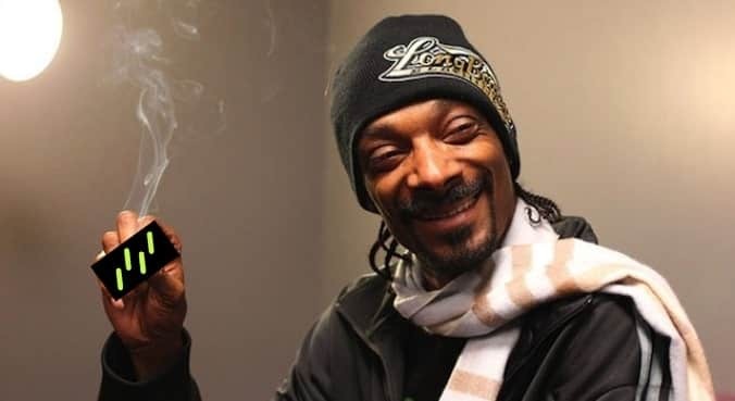Snoop Dogg holding the drizzle logo like a joint.