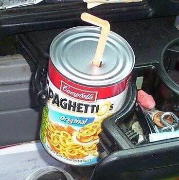 A can of Spaghettios with a straw sticking out of it