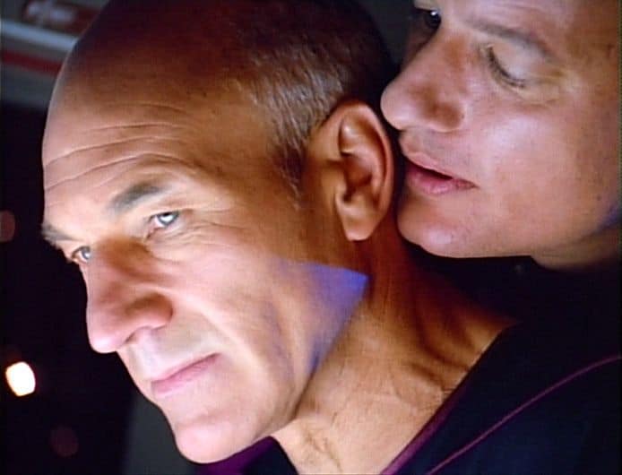One person whispering into Patrick Stewart's ear in Star Trek