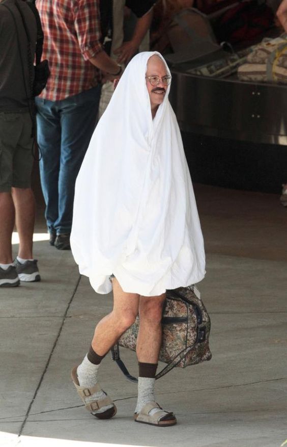 Tobias Funke from Arrested Development walking around in a towel and socks and sandals