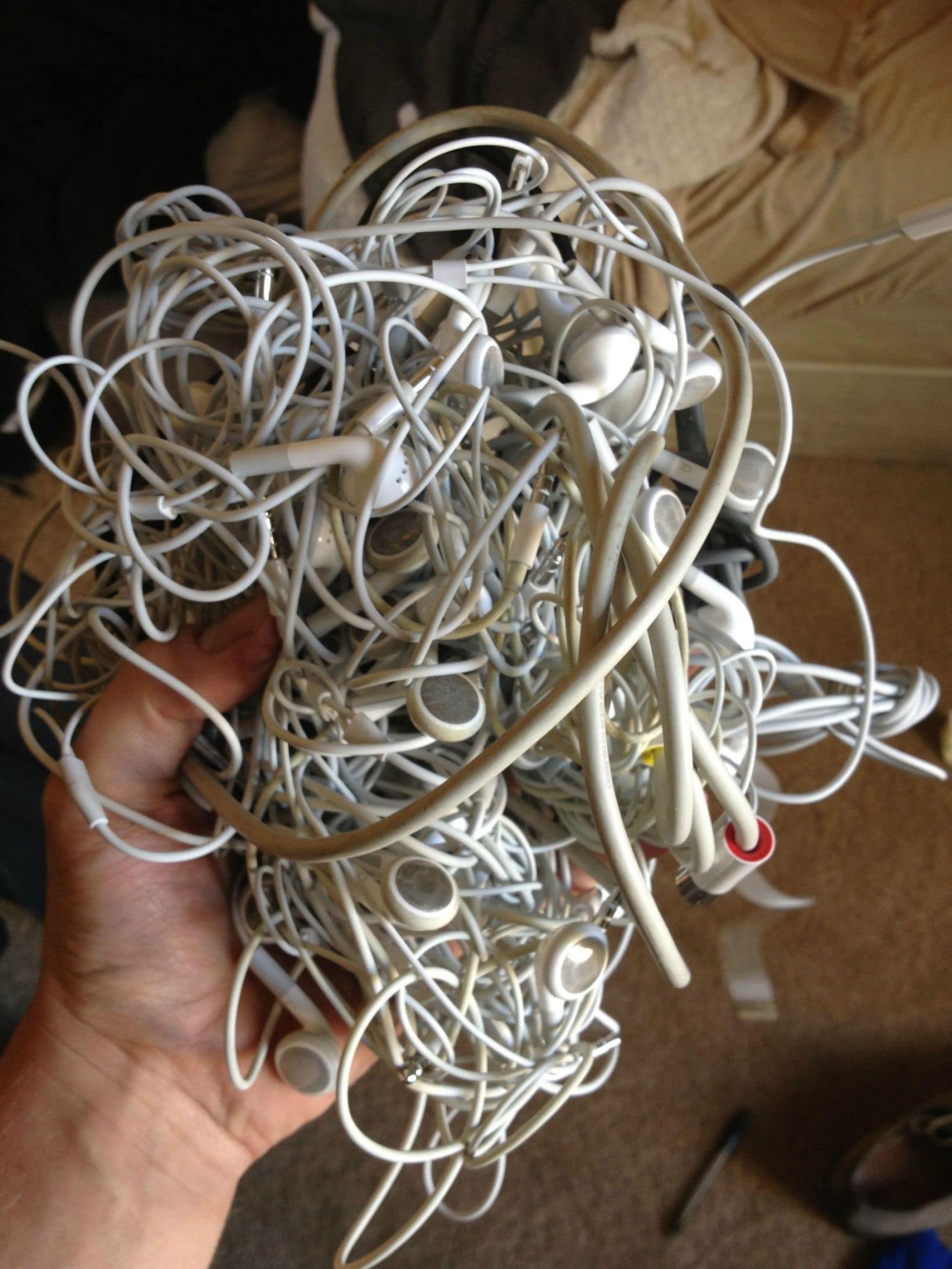 A bunch of tangled chords and headphones