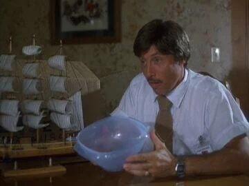 Uncle Rico holding a tupperware container