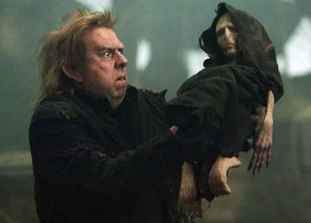 Wormtail holding up tiny Voldemort from Harry Potter